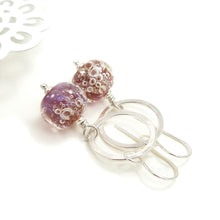 Silver earrings with pink bubble beads on a white background