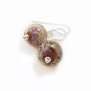 Pair of glass bead earrings with silver hooks on a white background