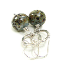 Duck Egg Blue speckled earrings with silver ring on a white background
