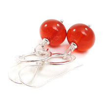 Orange Bead earrings with silver rings on a white background
