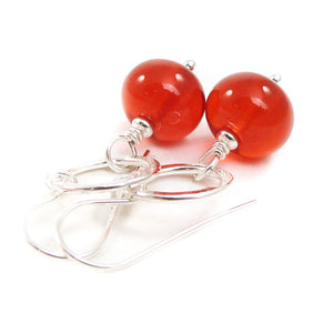Orange Bead earrings with silver rings on a white background