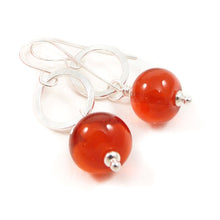 Orange Bead earrings with silver rings on a white background