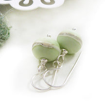 Pale green lampwork glass bead and silver drop earrings