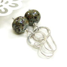 Duck Egg Blue speckled earrings with silver ring on a white background