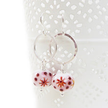 Red and White Bead earrings with silver ring on a white background