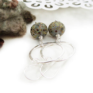 Silver Circle and speckled glass bead drop earrings on a white background