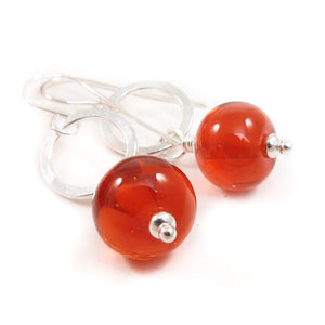 Orange Bead earrings with silver rings on a white background