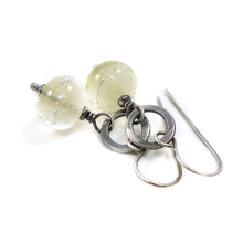 Silver earrings with translucent pale Yellow beads on a white background