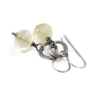 Silver earrings with translucent pale Yellow beads on a white background