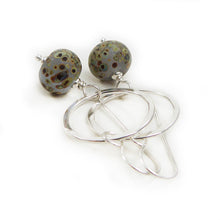 Silver Circle and speckled glass bead drop earrings on a white background