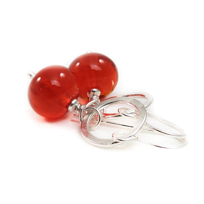 Orange Bead earrings with silver rings on a white background
