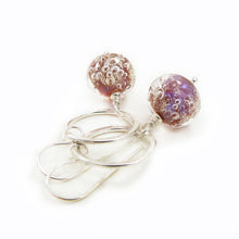 Silver earrings with pink bubble beads on a white background