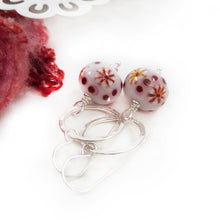 Red and White Bead earrings with silver ring on a white background