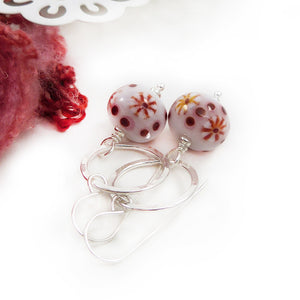 Red and White Bead earrings with silver ring on a white background