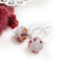 Red and White Bead earrings with silver ring on a white background