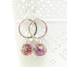 Silver earrings with pink bubble bead accents on a white background