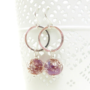 Silver earrings with pink bubble bead accents on a white background
