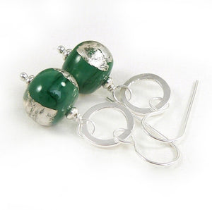 Silver drop earrings with silver circles and green glass beads decorated with silver leaf