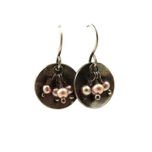 Dangle earrings with pink freshwater pearls hanging in an oxidised sterling silver dish