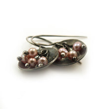 Dangle earrings with pink freshwater pearls hanging in an oxidised sterling silver dish