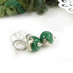 Silver drop earrings with silver circles and green glass beads decorated with silver leaf