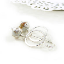 white lampwork glass bead and silver circle drop earrings