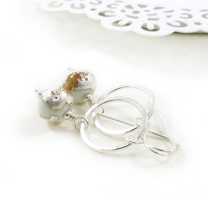 white lampwork glass bead and silver circle drop earrings